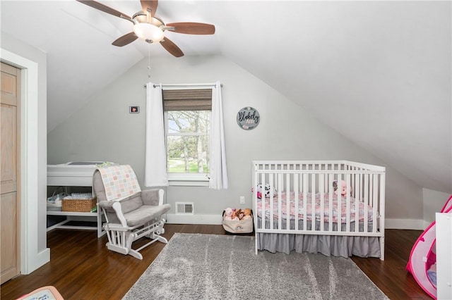 bedroom with ceiling fan, lofted ceiling, wood finished floors, and visible vents