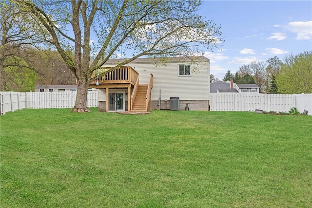 rear view of house featuring a wooden deck, central AC, a fenced backyard, a yard, and stairs