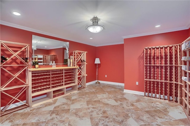 wine room featuring baseboards, ornamental molding, and recessed lighting