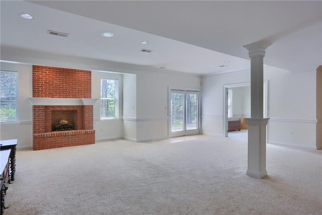 unfurnished living room featuring recessed lighting, carpet floors, ornate columns, and visible vents