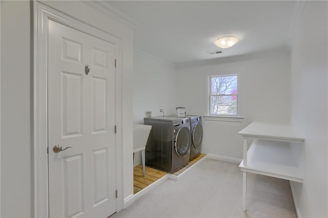 laundry area featuring laundry area, baseboards, washer and dryer, and visible vents
