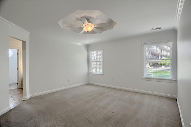 unfurnished room with baseboards, a ceiling fan, carpet flooring, and visible vents