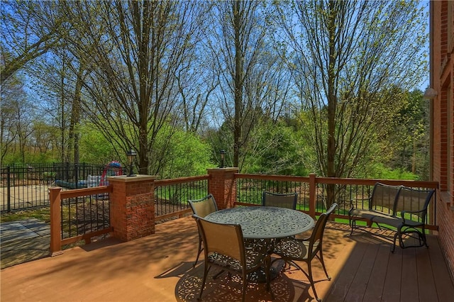 wooden deck featuring outdoor dining area and fence