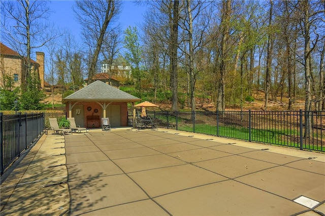 view of patio / terrace with a fenced in pool, fence, and an outbuilding