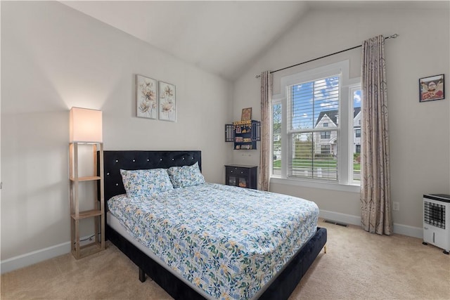 bedroom with baseboards, visible vents, light carpet, and lofted ceiling
