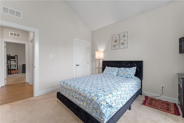 bedroom with carpet floors, baseboards, high vaulted ceiling, and visible vents