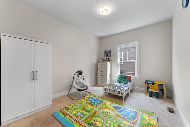 bedroom with carpet floors, baseboards, and visible vents