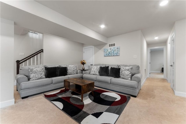 living room with visible vents, recessed lighting, baseboards, and light carpet