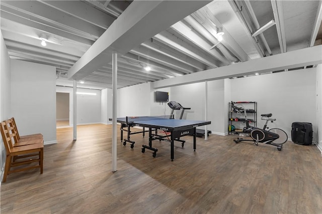 playroom featuring baseboards and wood finished floors