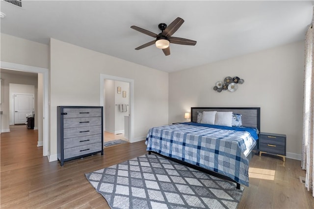 bedroom featuring baseboards, ceiling fan, and wood finished floors