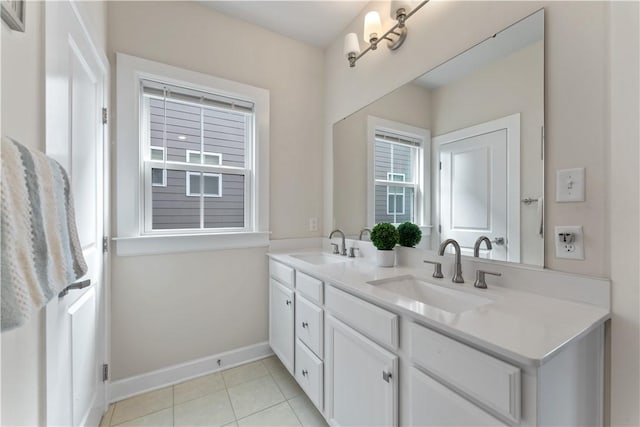 full bathroom with baseboards, a sink, tile patterned floors, and double vanity