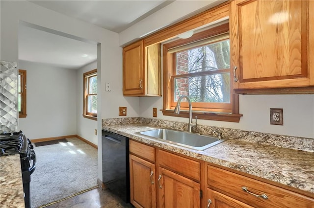 kitchen with dark carpet, a sink, black appliances, and a healthy amount of sunlight