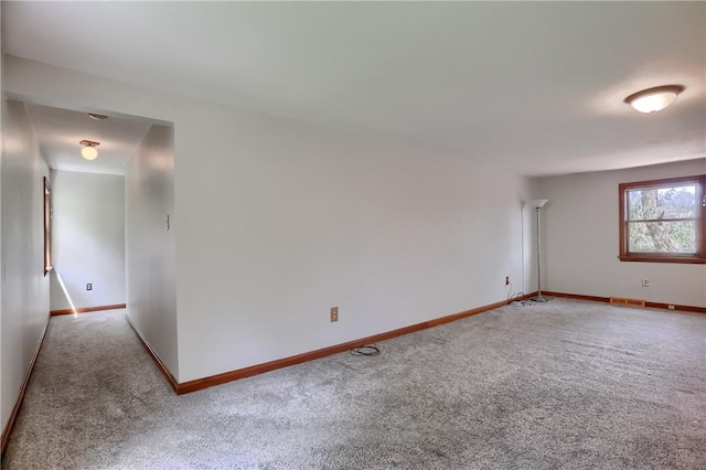 carpeted empty room with baseboards and visible vents