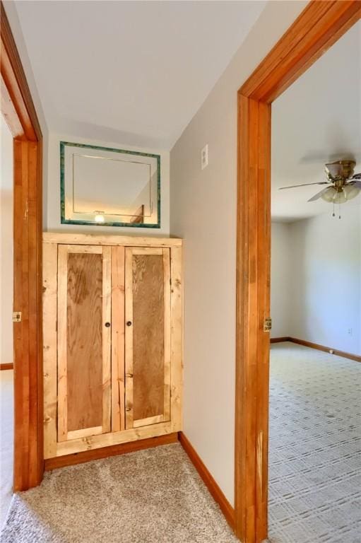 interior space with baseboards and carpet flooring