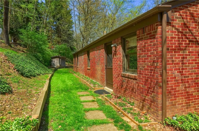 view of home's exterior with a yard and brick siding