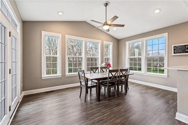 dining space with baseboards, a ceiling fan, vaulted ceiling, and dark wood-style flooring