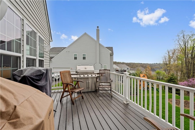wooden terrace featuring a grill