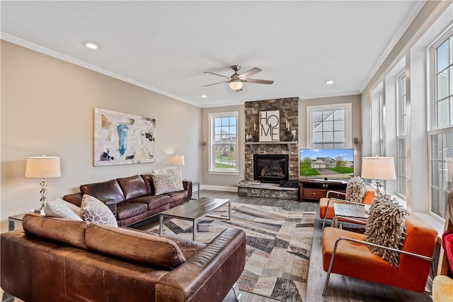 living area with a fireplace, a ceiling fan, recessed lighting, wood finished floors, and ornamental molding