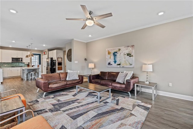 living area with baseboards, recessed lighting, ceiling fan, and wood finished floors