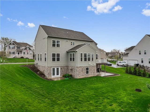 back of house with french doors, a patio, a yard, and a residential view