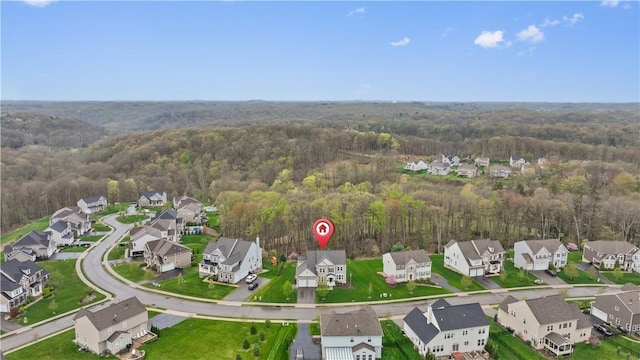 drone / aerial view with a residential view and a view of trees