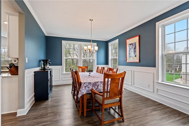 dining room featuring a notable chandelier, ornamental molding, and a wealth of natural light