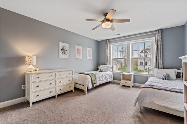 bedroom with baseboards, ceiling fan, light carpet, and visible vents