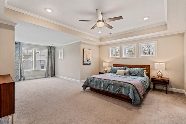 carpeted bedroom with baseboards, ornamental molding, multiple windows, and a raised ceiling
