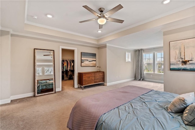 bedroom with baseboards, light carpet, and a walk in closet