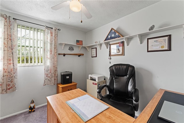 office area with carpet floors, a textured ceiling, baseboards, and ceiling fan