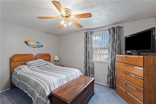 bedroom with baseboards, carpet flooring, a textured ceiling, and a ceiling fan