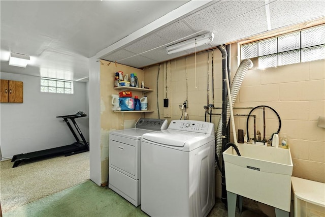 laundry room with independent washer and dryer, laundry area, light carpet, a sink, and concrete block wall
