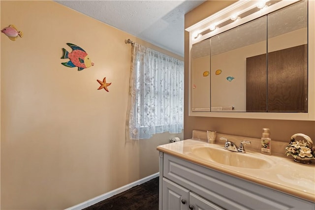 bathroom with vanity and baseboards