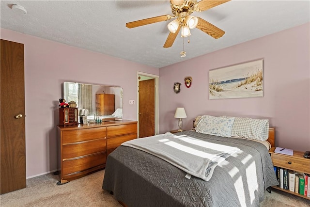bedroom featuring a ceiling fan and light colored carpet