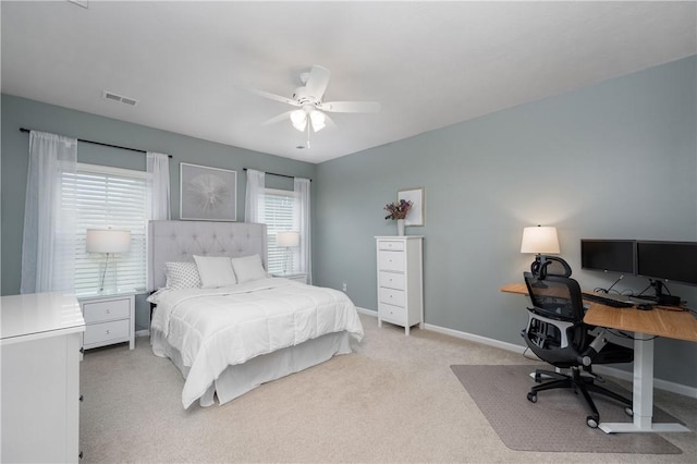 bedroom featuring baseboards, visible vents, ceiling fan, and light colored carpet