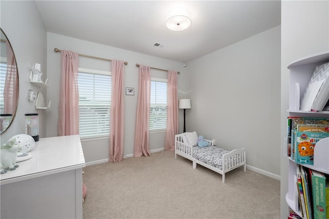 carpeted bedroom with baseboards and visible vents