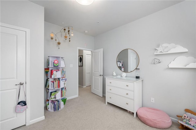 game room with baseboards and light carpet