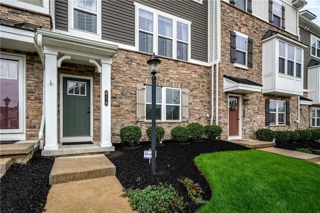 view of exterior entry featuring stone siding