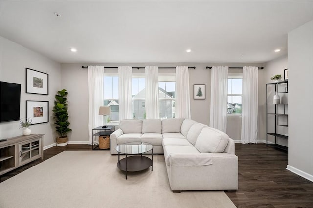 living area with recessed lighting, baseboards, and dark wood-style flooring