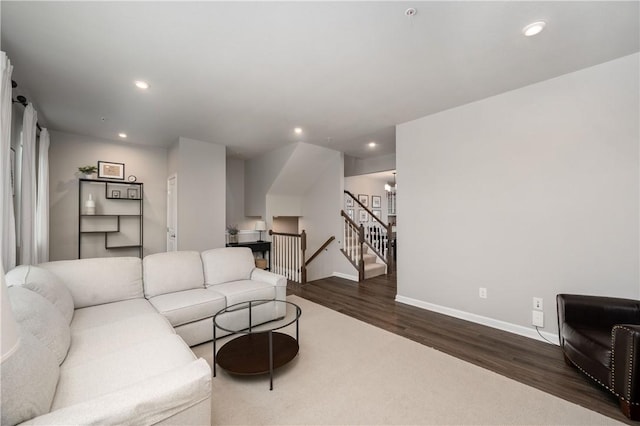 living area with baseboards, recessed lighting, and dark wood finished floors