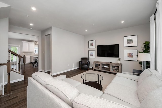 living area with recessed lighting, baseboards, and dark wood finished floors