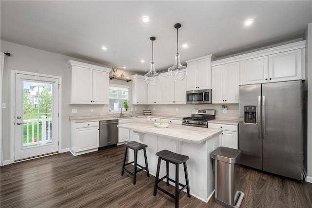 kitchen featuring light countertops, stainless steel appliances, white cabinets, and a sink