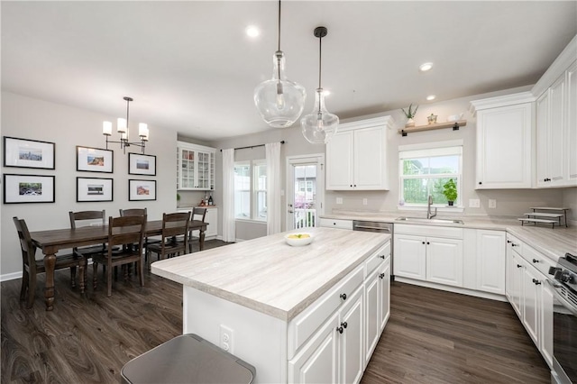 kitchen with dark wood-style flooring, a sink, light countertops, a chandelier, and recessed lighting