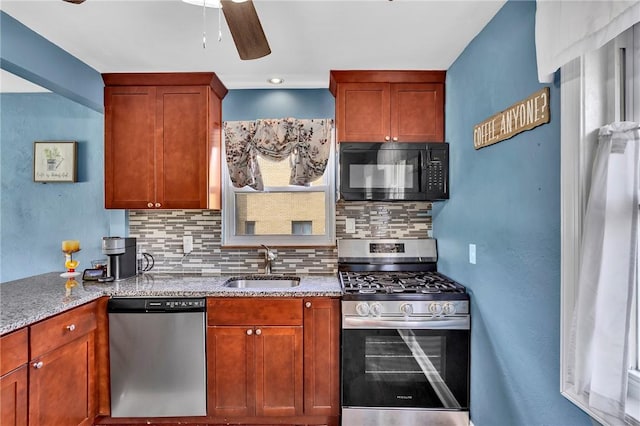 kitchen featuring backsplash, stainless steel appliances, a ceiling fan, and a sink
