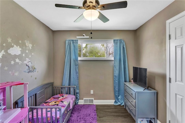 bedroom with visible vents, baseboards, ceiling fan, and wood finished floors