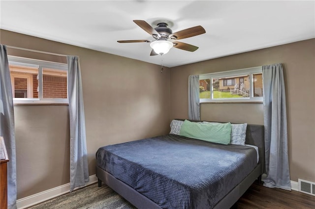 bedroom with a ceiling fan, baseboards, and visible vents