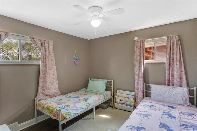 bedroom featuring a ceiling fan, baseboards, and visible vents