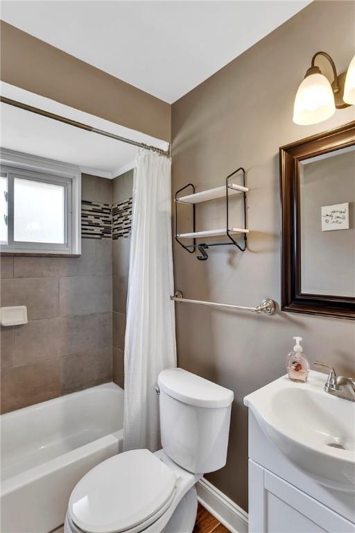 bathroom with toilet, shower / bath combo, and vanity