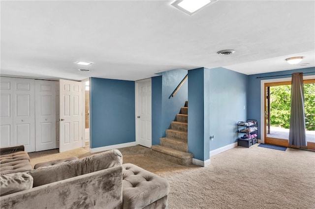 living area with baseboards, carpet, visible vents, and stairway