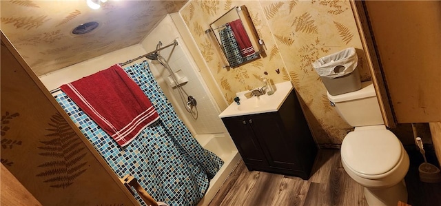 54 Old Dinnerbell Rd, Farmington, PA 15437 - full bathroom featuring vanity, toilet, shower / bath combination with curtain, wallpapered walls, and wood finished floors